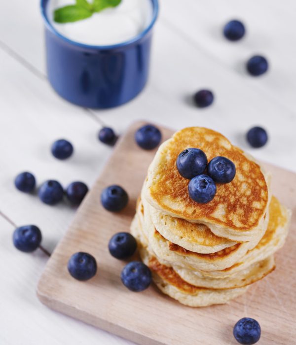 Pancakes with blueberry on cutting board